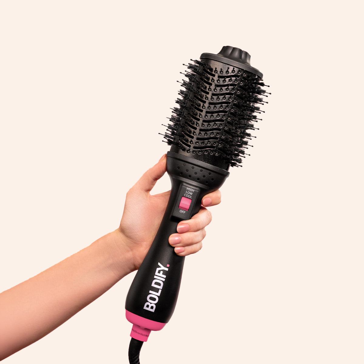 Holding a professional blow dry brush BOLDIFY