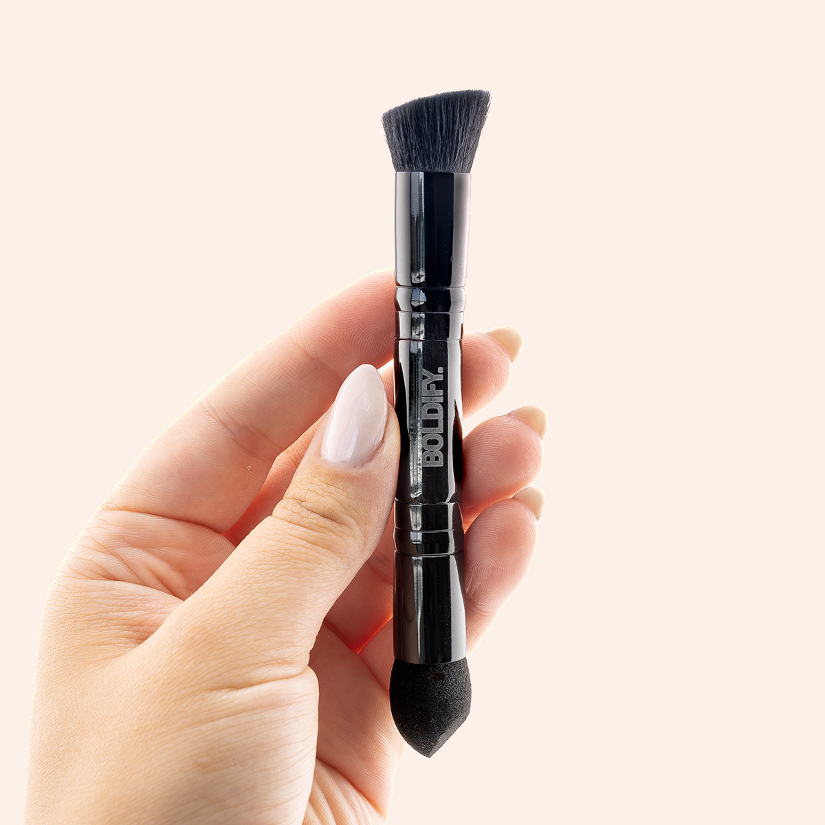 Dual-ended brush with one end being a sponge tip and the other a brush, predominantly black in color